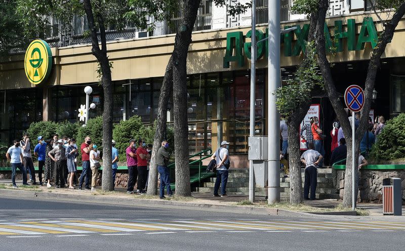 People queue outside a pharmacy amid the outbreak of the coronavirus disease (COVID-19) in Almaty