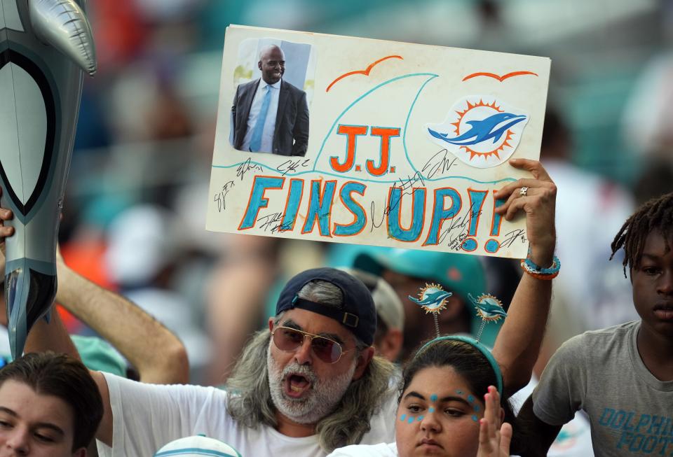 Miami Dolphins fans take time during the season opener against the New England Patriots to remember the late Jason Jenkins, the former senior vice president of communications and community affairs for the Miami Dolphins who recently passed. Hard Rock Stadium in Miami Gardens, Sept. 11, 2022. 