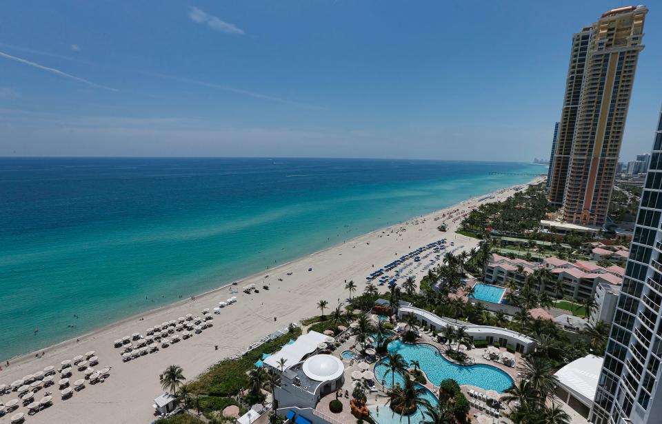 A general view from a balcony of the Trump Palace luxury condominiums on Sunny Isles Beach, Florida, on May 15, 2017.
More than half, 54 percent, of Miami foreign real estate buyers come from Latin America, according to the National Association of Realtors. Another 18 percent are Europeans and 13 percent Canadians. A closer look at the figures show that Canadians were the top buyers of luxury apartments in 2016, followed by Venezuelans and Brazilians. / AFP PHOTO / RHONA WISE        (Photo credit should read RHONA WISE/AFP via Getty Images)