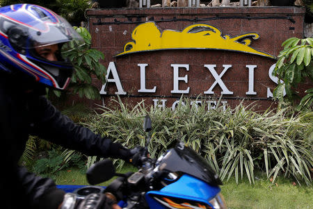 A motorist drives past the Alexis Hotel in Jakarta, Indonesia, October 19, 2017. Picture taken October 19, 2017. REUTERS/Beawiharta