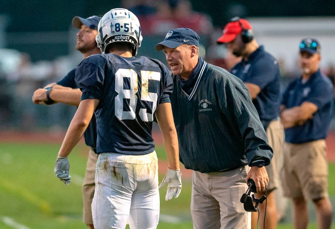 Penns Valley football coach Martin Tobias talks to Tanner Ilgen during the game against Philipsburg-Osceola on Friday, Sept. 17, 2021.