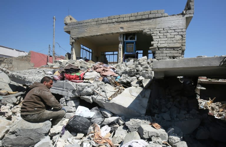 An Iraqi man in the rubble of destroyed houses in Mosul's al-Jadida area on March 26, 2017, after air strikes which reportedly killed civilians