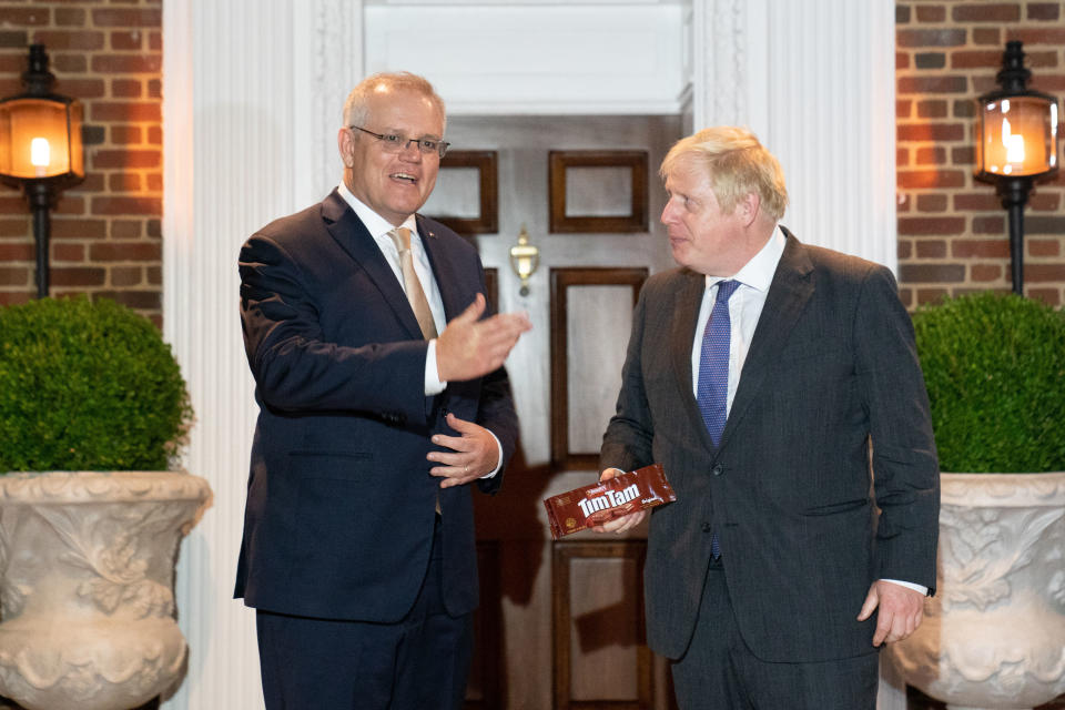 UK Prime Minister Boris Johnson (pictured right) receives a packet of Tim Tams from Australian Prime Minister Scott Morrison (pictured left).