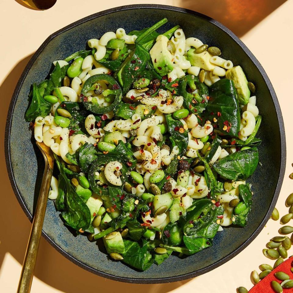 vegan macaroni salad with spinach, edamame, avocado, and pepitas