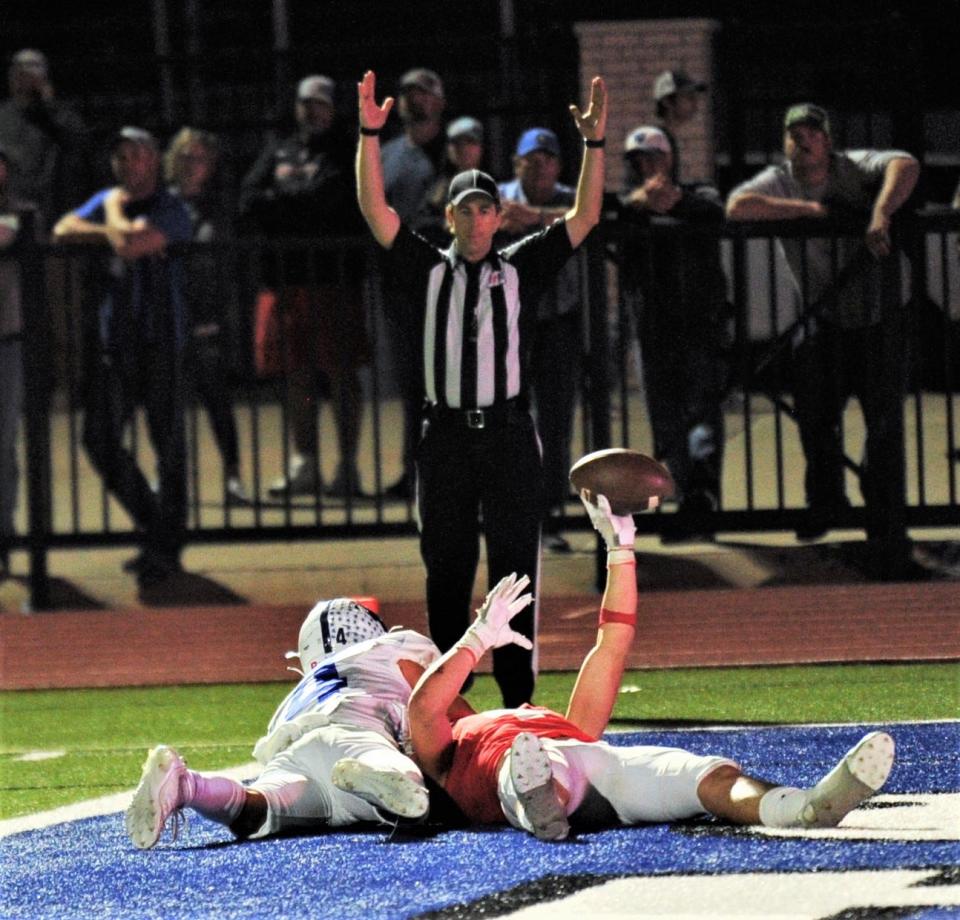 Albany's Coy Lafevre, right, holds up the ball as an official signals for the TD. It came after Lafevre tumbled into the end zone for a 28-yard TD catch after fighting off a Windthorst defender. The score gave the Lions a 28-6 lead with 8:42 left in the third quarter.