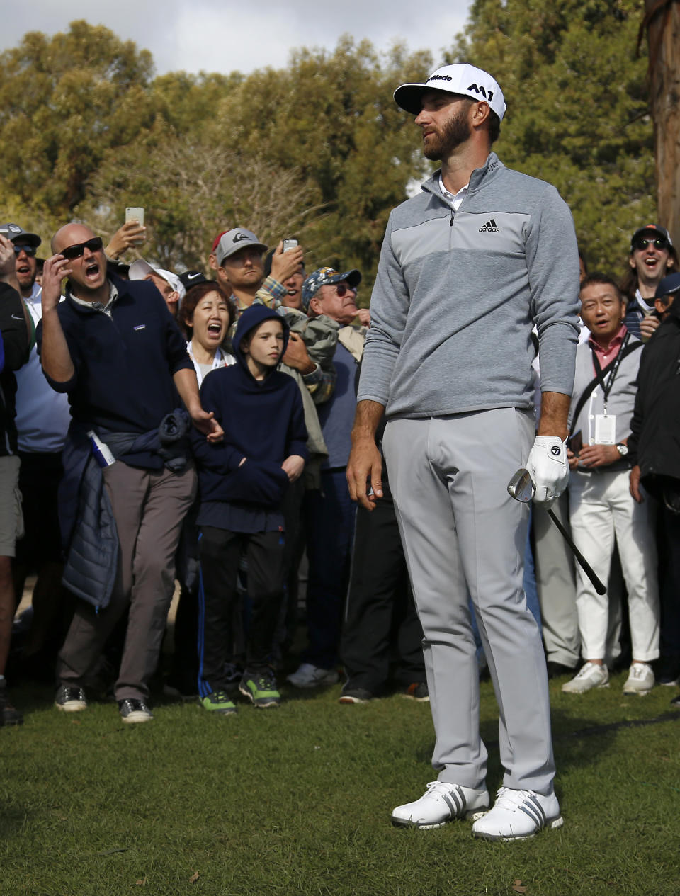 Dustin Johnson and spectators react as Johnson nearly holes out after chipping onto the eighth green during the final round of the Genesis Open golf tournament at Riviera Country Club Sunday, Feb. 19, 2017, in the Pacific Palisades area of Los Angeles. (AP Photo/Ryan Kang)