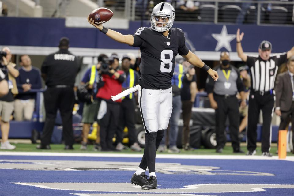 Las Vegas Raiders quarterback Marcus Mariota (8) celebrates scoring a touchdown in the second half of an NFL football game against the Dallas Cowboys in Arlington, Texas, Thursday, Nov. 25, 2021. (AP Photo/Michael Ainsworth)