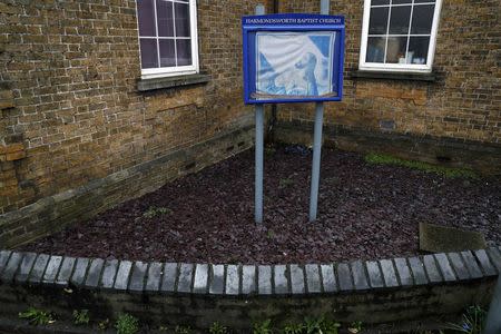 A picture of a praying Jesus is seen outside the Baptist church in the village of Harmondsworth, very close to the proposed site of Heathrow airport's third runway, near London, Britain February 2, 2017. REUTERS/Stefan Wermuth