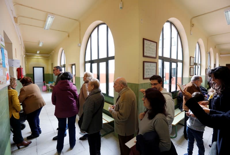 People line up to vote during general election in Seville