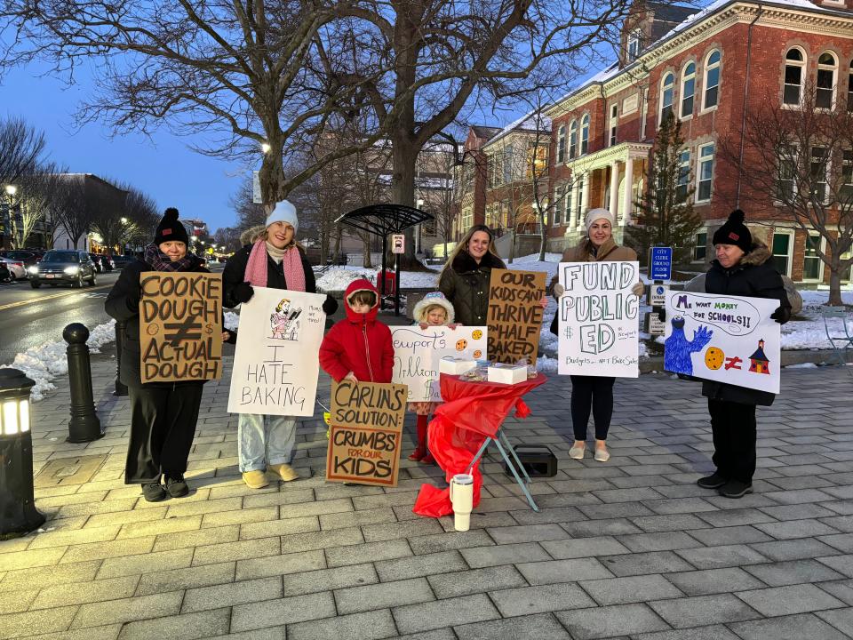 A group of parents and friends held a tongue-in-cheek bake sale to raise millions for the new Rogers High School building.