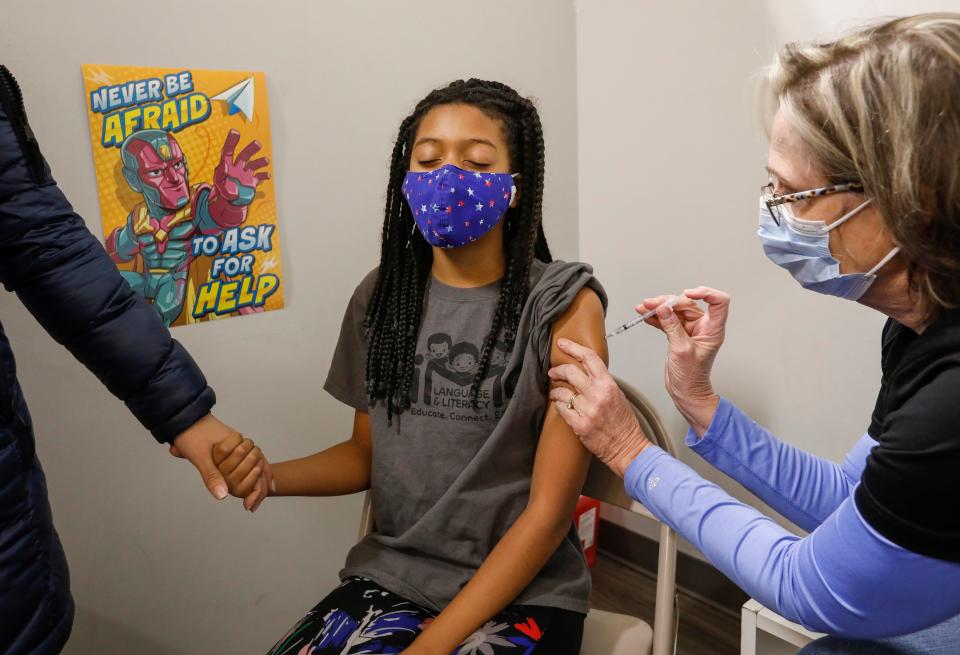 Ariana Morris, 10, receives her second dose of the COVID-19 vaccine from Linda Maddux, a registered nurse with the Springfield-Greene County Health Department, on Friday, Jan. 7, 2022.