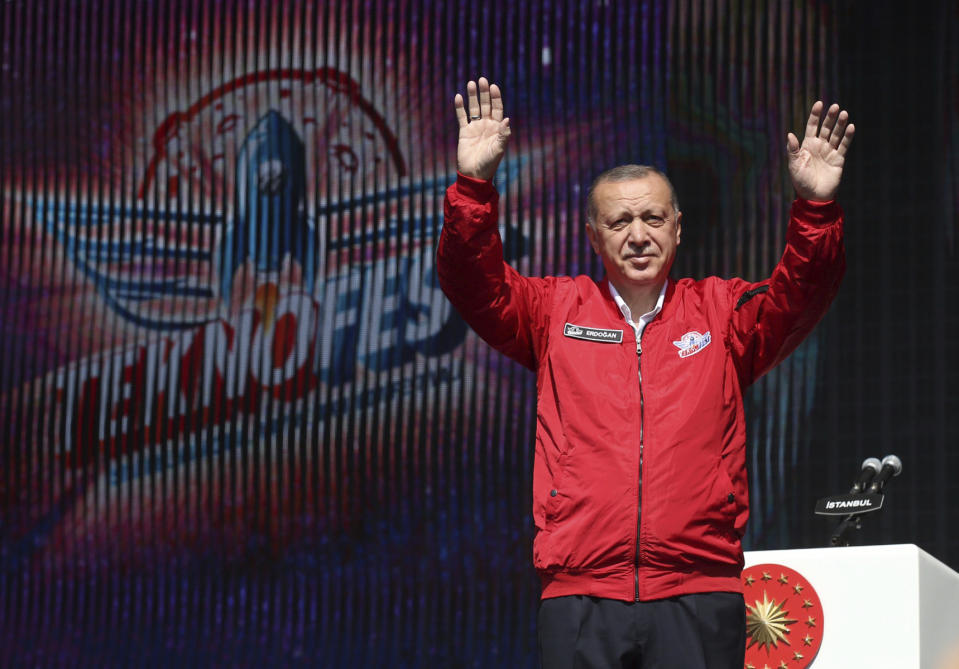 Turkey's President Recep Tayyip Erdogan salutes his supporters at a technology fair in Istanbul, Saturday, Sept. 21, 2019. Erdogan expressed frustration with what he said was the United States' continued support to Syrian Kurdish forces that Turkey regards as terrorists and reiterated that Turkey had completed all preparations for a possible unilateral military operation in northeast Syria, along the Turkish border east of the Euphrates River.(Presidential Press Service via AP, Pool)