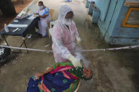 A health worker collects a nasal swab sample to test for COVID-19 in Hyderabad, India, Monday, Sept. 21, 2020. The nation of 1.3 billion people is expected to become the coronavirus pandemic's worst-hit country within weeks, surpassing the United States.(AP Photo/Mahesh Kumar A.)