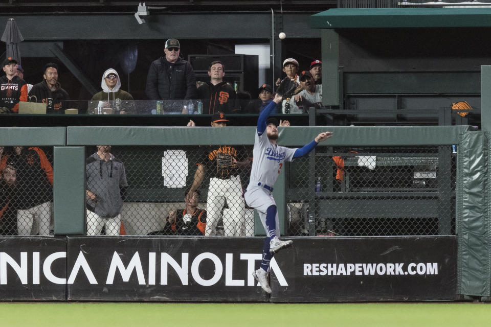 Los Angeles Dodgers center fielder Cody Bellinger catches a deep fly ball off the bat of San Francisco Giants' Wilmer Flores during the eighth inning of a baseball game in San Francisco, Sunday Sept. 18, 2022. (AP Photo/John Hefti)