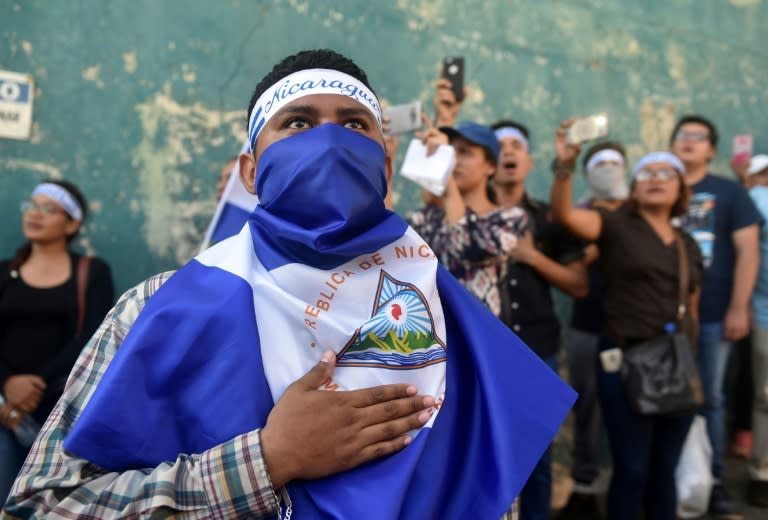 Demonstrators sing the national anthem in front of the Police Station during a protest against the government of President Daniel Ortega in Managua
