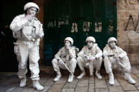 Israeli performance artists rest during a parade marking Jerusalem Day in Jerusalem's Old City May 20, 2012. Jerusalem Day marks the anniversary of Israel's capture of the Eastern part of the city during the 1967 Middle East War. Israel annexed East Jerusalem as part of its capital in a move not recognized internationally. REUTERS/Darren Whiteside