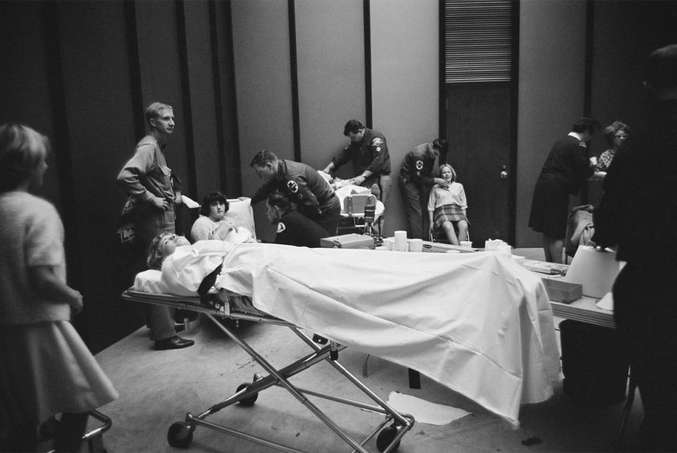 Beatles fans are attended to by paramedics, having been overcome during the group’s US tour, August 1964 (Getty)