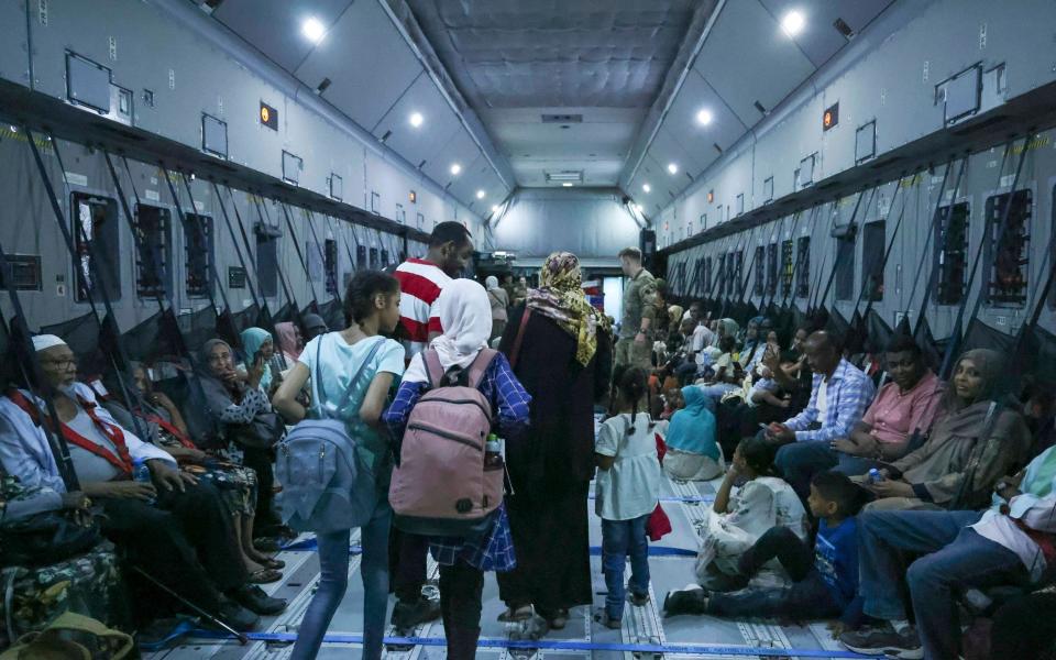 A family boarding an RAF Plane during the evacuation from Wadi Seidna Air Base in Sudan - Royal Navy