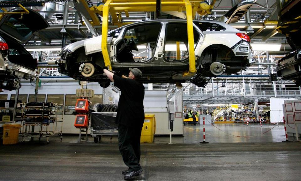 A Vauxhall employee works on an Astra Sports Tourer