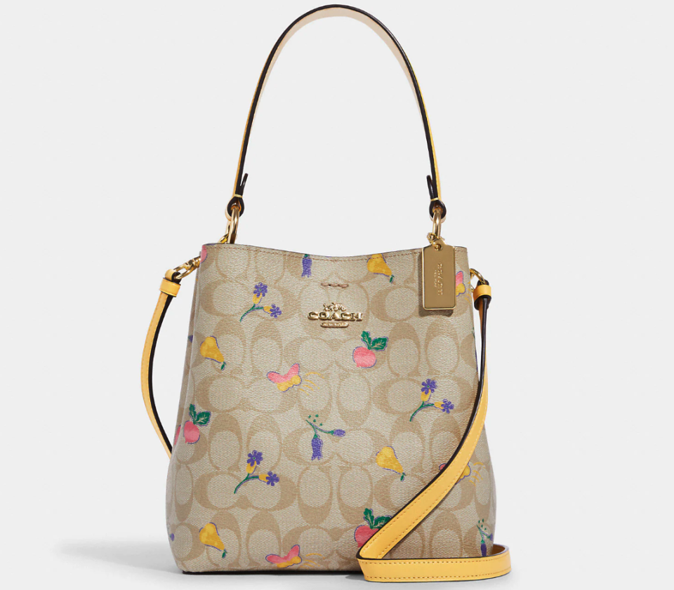 Small Town Bucket Bag In Signature Canvas With Dreamy Veggie Print. Image via Coach Outlet.