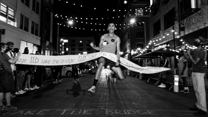 A man jumps in the air as he finishes the race