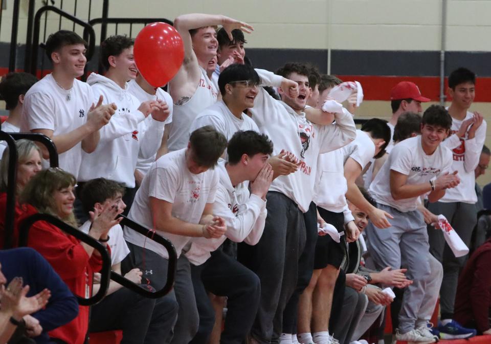 Fans in the "Red Tide" section at Tappan Zee High School in Orangeburg cheer after a slam dunk during a game with Nanuet Feb. 7, 2024.