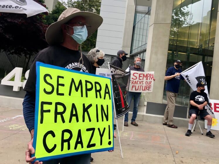 One of about 100 protesters in front of the Sempra Energy building in downtown San Diego on Friday, May 14.