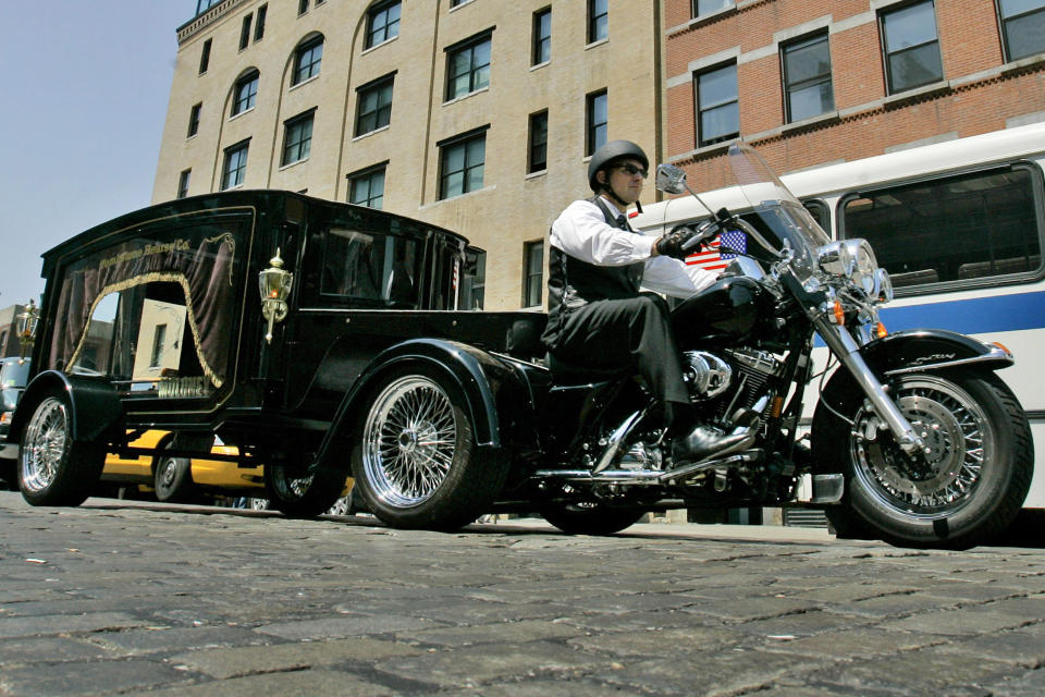 FILE — Peter Moloney, of Moloney Family Funeral Homes in Lake Ronkonkoma, N.Y., rides his Harley Davidson hearse from the Tombstone Hearse Co. of Alum Bank, Pa., in New York, May 24, 2007. Maloney was arrested Wednesday, June 7, 2023, on charges that he sprayed wasp killer at police officers and assaulted journalists — including an Associated Press photographer — during the Jan. 6, 2021, riot at the U.S. Capitol, authorities said. (AP Photo/Richard Drew, File)