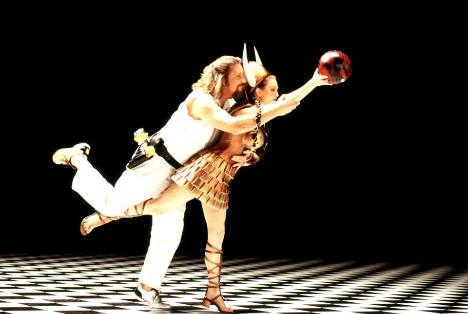 A man and a woman bowl together