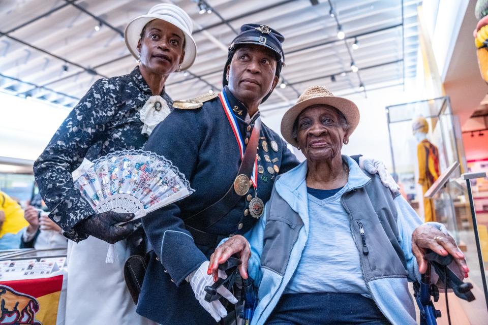 Sherry Cruz (left) and Deputy Commander Michelle London Marable (center) of The Buffalo Soldiers of the Arizona Territory - Ladies and Gentlemen of the Regiment, pose for a photo with Esther Ellis, right, during a Juneteenth celebration at the Tempe History Museum in Tempe on June 17, 2023.