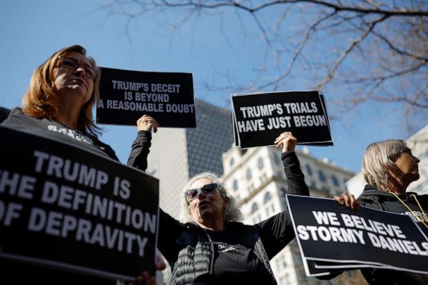 PHOTO: Protesters hold signs outside Manhattan Criminal Courthouse on the day of former President Donald Trump's planned court appearance after his indictment by a Manhattan grand jury, in New York City, April 4, 2023. (Amanda Perobelli/Reuters)