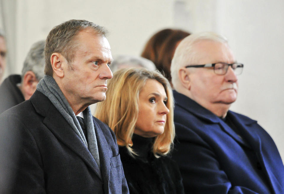 European Council President Donald Tusk, left, his wife Malgorzata Tusk, and Poland's former president and Solidarity pro-democracy movement founder, Lech Walesa, attending the funeral of slain Gdansk city Mayor Pawel Adamowicz, at St. Mary's Basilica in Gdansk, Poland, on Saturday, Jan. 19, 2019. Adamowicz died Monday after being stabbed the night before at a charity event by an ex-convict with a grudge against an opposition party that Adamowicz once belonged to..(AP Photo/Wojtek Strozyk)