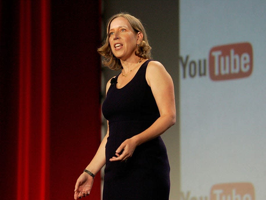 Susan Wojcicki giving a speech with the YouTube logo behind her.