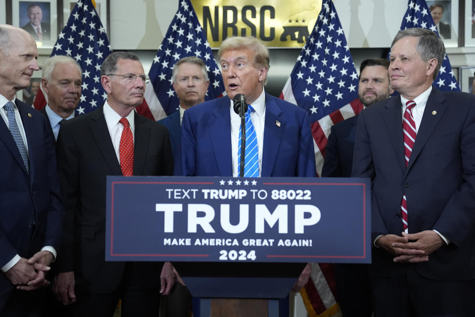 Republican presidential candidate former President Donald Trump speaks with reporters at the National Republican Senatorial Committee, Thursday, June 13, 2024, in Washington, as from left, Sen. Rick Scott, R-Fla., Sen. Ron Johnson, R-Wis., Sen. John Barrasso, R-Wyo., Sen Roger Marshall, R-Kan., Sen. J.D. Vance, R-Ohio, and Sen. Steve Daines, R-Mont., listen. (AP Photo/Evan Vucci)