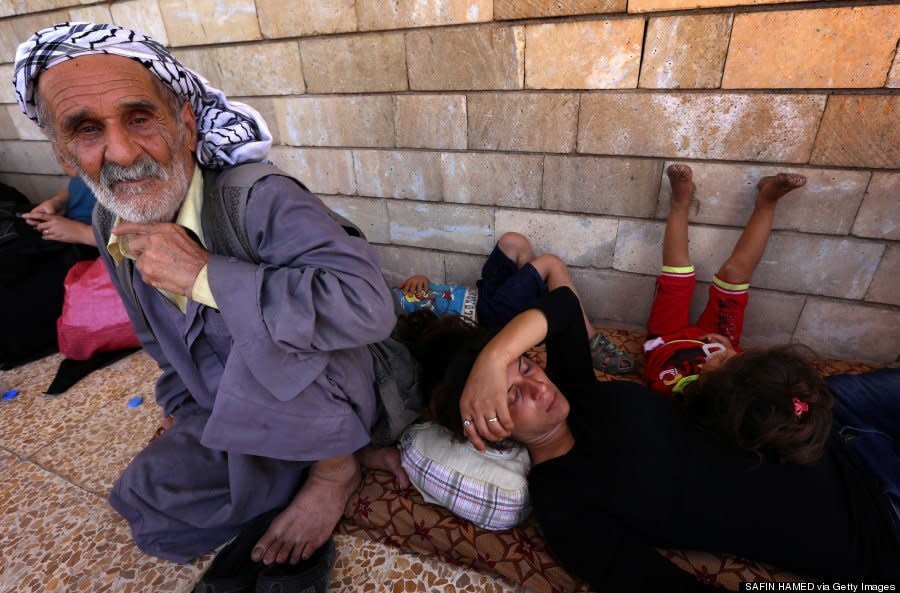 Iraqi Christians who fled the violence in the village of Qaraqush rest upon their arrival at the Saint-Joseph church in the Kurdish city of Arbil in Iraq's autonomous Kurdistan region on August 7, 2014. (SAFIN HAMED/AFP/Getty Images)