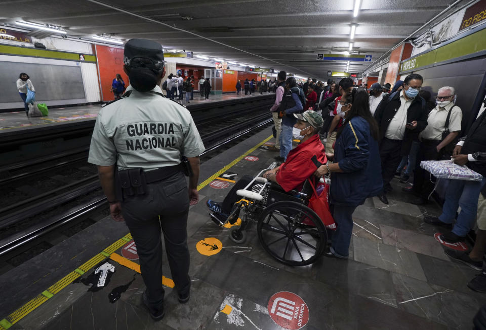 A member of the Mexican National Guard stands on guard at a subway station in Mexico City, Thursday, Jan. 12, 2023. The mayor of Mexico City says that more the 6 thousand National Guard officers will be posted in the city's subway system after a series of accidents that officials say could be due to sabotage. (AP Photo/Fernando Llano)