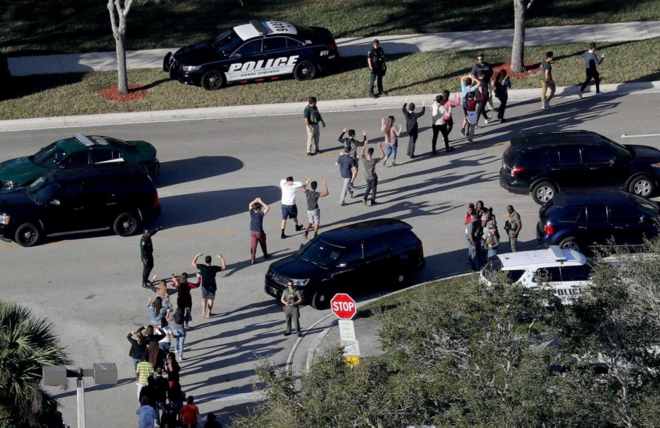 PHOTO: Students are evacuated by police out of Stoneman Douglas High School in Parkland, Fla., after a shooting, Feb. 14, 2018. (Mike Stocker/Sun Sentinel via Getty Images)