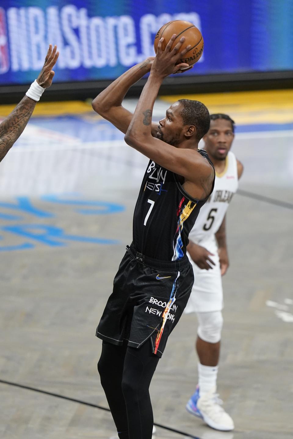 Brooklyn Nets' Kevin Durant (7) shoots over a defender during the first half of an NBA basketball game against the New Orleans Pelicans Wednesday, April 7, 2021, in New York. (AP Photo/Frank Franklin II)