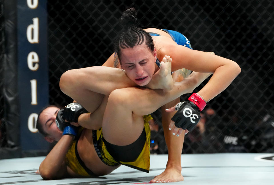 Dec 16, 2023; Las Vegas, Nevada, USA; Casey O’Neill (red gloves) fights Ariane Lipski (blue gloves) during UFC 296 at T-Mobile Arena. Mandatory Credit: Stephen R. Sylvanie-USA TODAY Sports