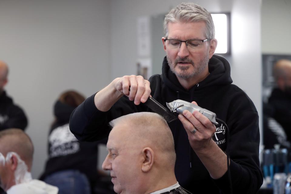 Barber Greg Cacciatore trims Canal Winchester resident Steve Riddle's hair Nov. 9 at Randy's Barbershop in Pickerington.