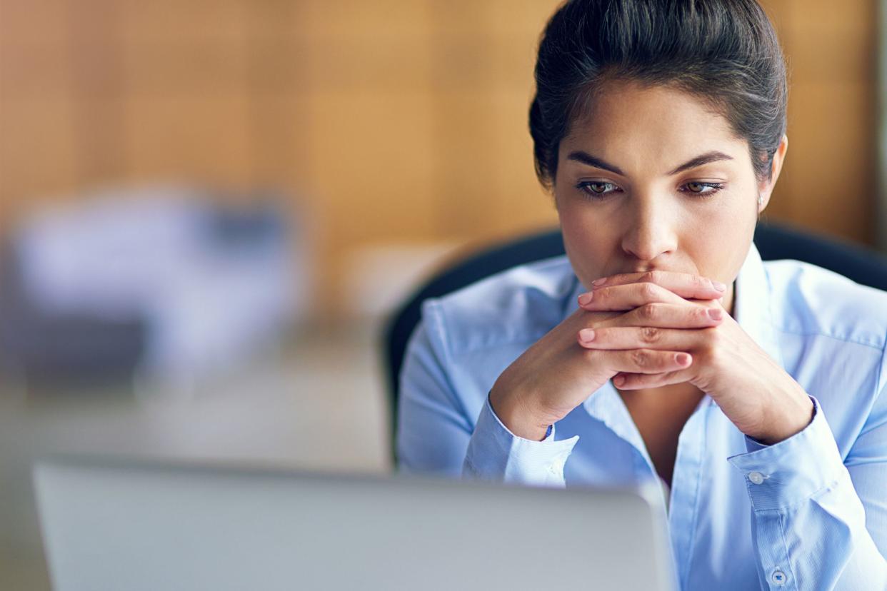 businesswomen with hands in front of her mouth, stressed