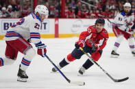 New York Rangers defenseman Adam Fox (23) skates with the puck as Washington Capitals left wing Conor Sheary (73) challenges him for it during the third period of an NHL hockey game, Saturday, Feb. 25, 2023, in Washington. The Capitals won 6-3. (AP Photo/Julio Cortez)