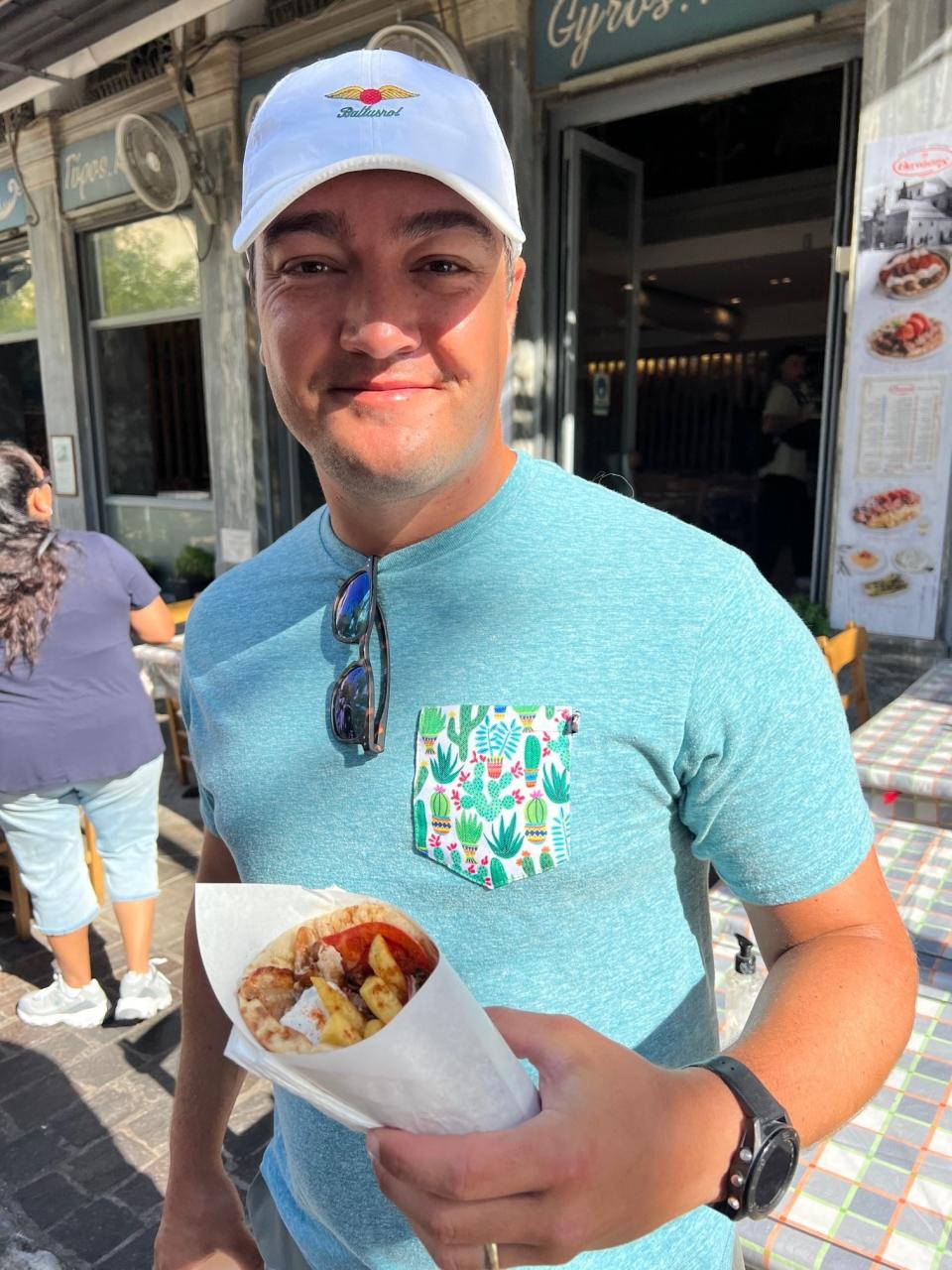 A man holding a gyro.