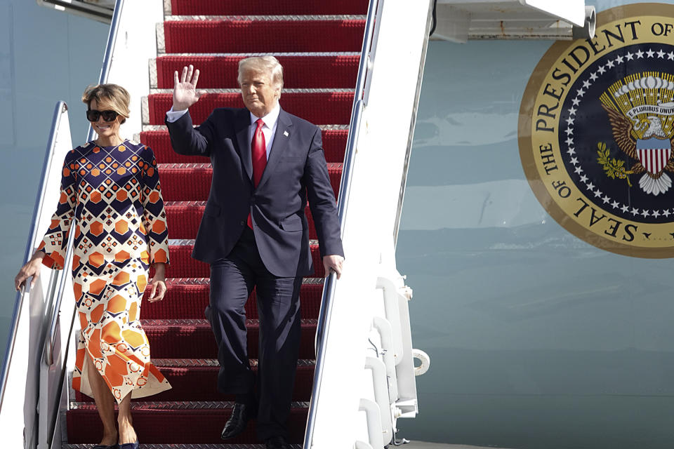 President Donald Trump waves to a handful of supporters as he arrives with first lady Melania Trump at Palm Beach International Airport in West Palm Beach, Fla., Wednesday, Jan. 20, 2021. (Joe Cavaretta/South Florida Sun-Sentinel via AP)