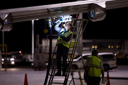 Jet fuel is siphoned directly between two Qantas aircraft on the tarmac of Auckland Airport in New Zealand, September 21, 2017, during fuel shortages which have affected New Zealand's aviation sector. Qantas/Ollie Dale/Handout via REUTERS