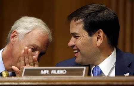 U.S. Senator and Republican presidential candidate Marco Rubio (R-FL) laughs as he listens to a comment from U.S. Senator Ron Johnson (R-WI) during a U.S. Senate Foreign Relations committee hearing on U.S.-Cuba relations on Capitol Hill in Washington May 20, 2015. REUTERS/Jim Bourg