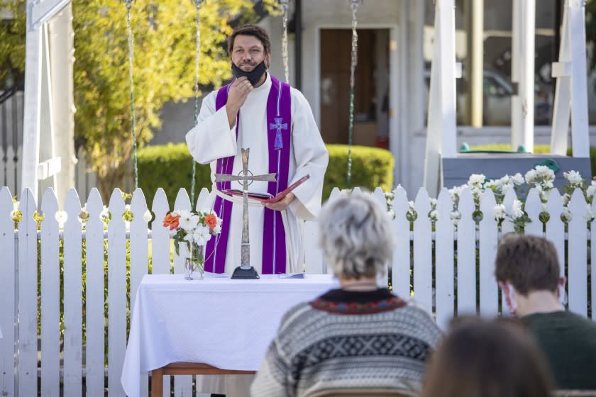 SAN PEDRO, CA - DECEMBER 13: Rev. Morgan Berg takes off his face mask to deliver a sermon at the Norwegian Seaman's Church on Sunday, Dec. 13, 2020 in San Pedro, CA. (Brian van der Brug / Los Angeles Times)