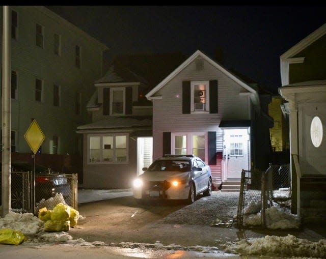 A police officer keeps watch on a Douglas Street house late Wednesday.