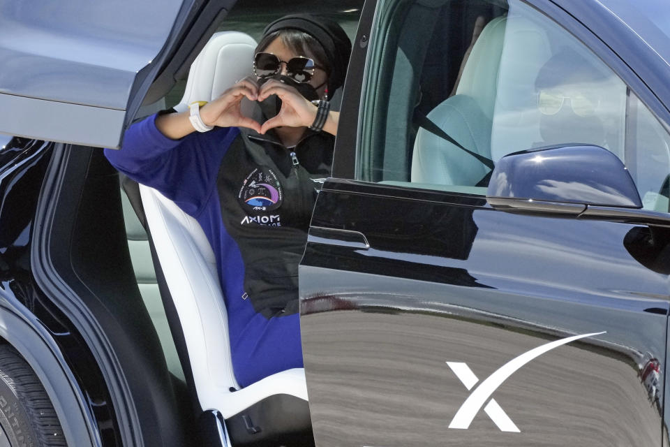 Saudi Arabian astronaut Rayyanah Barnawi makes a heart with her hands as she heads out to prepare for this evening's launch aboard a SpaceX Falcon 9 rocket at Kennedy Space Center in Cape Canaveral, Fla., Sunday, May 21, 2023. (AP Photo/John Raoux)