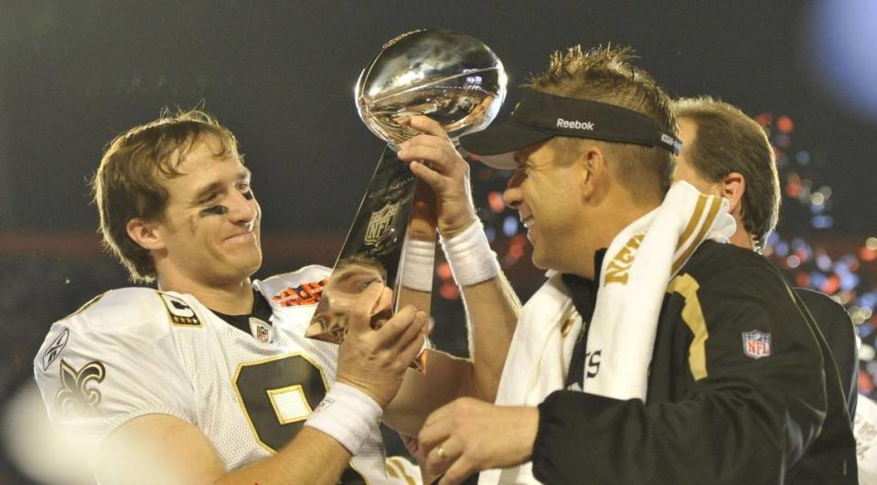 Former New Orleans Saints quarterback Drew Brees and head coach Sean Payton hold the NFL trophy after winning Super Bowl XLIV.